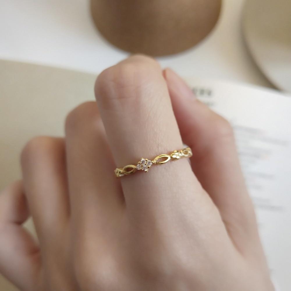 Close-up of the Golden Open Ring worn on the ring finger