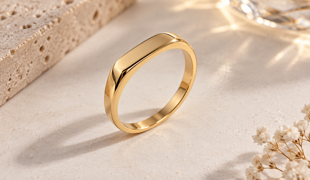 Glow Signet Ring standing on a stone surface with soft light and dried flowers